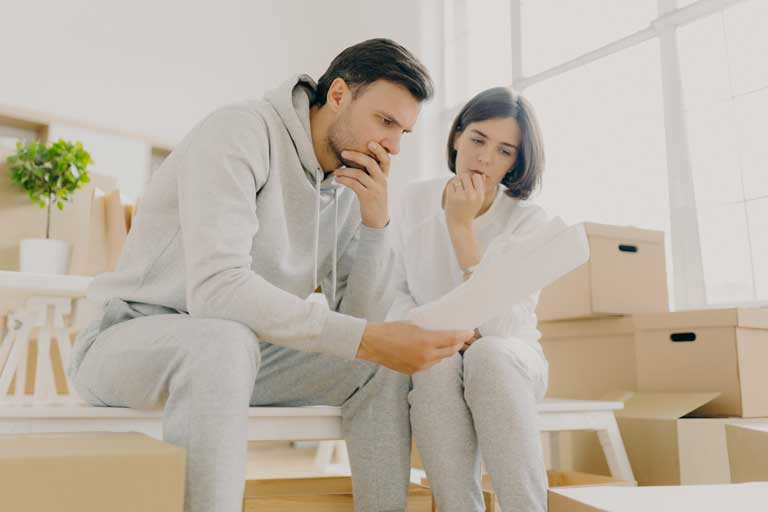 Worried couple read letter from bank, get notification for paying bills and rent