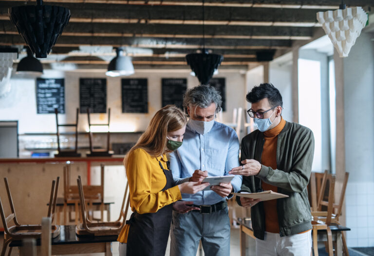 Family of business owners going over paperwork inside the business