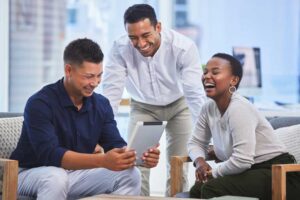 Executives laughing checking business reports