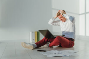 Frustrated Businessman woking on a laptop from home