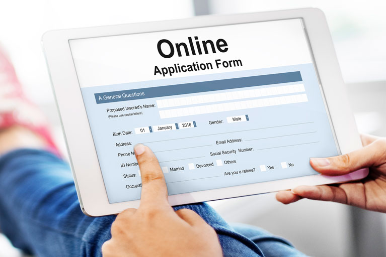 Person filling out an online application on a tablet