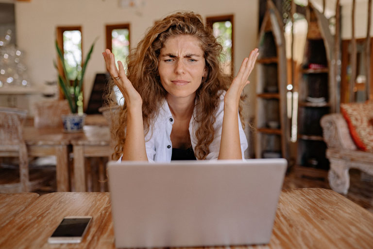 Frustrated woman looking at a laptop screen