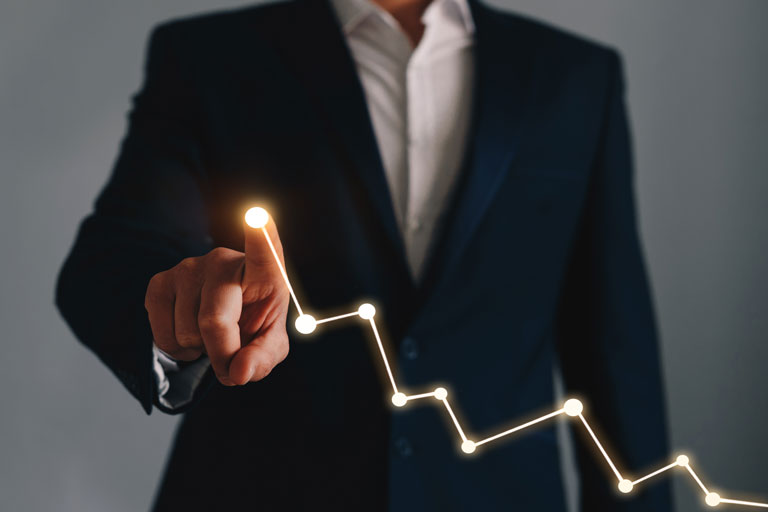 Businessman drawing an uptrend graphic with his finger