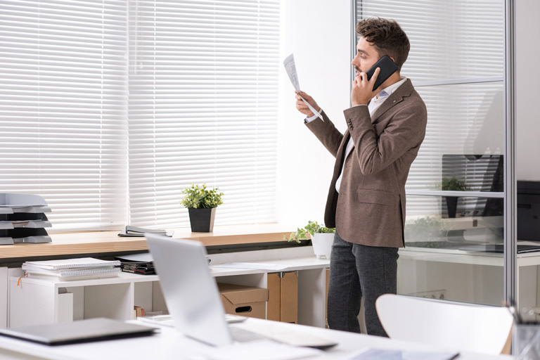 Business professional talking on the phone inside an office