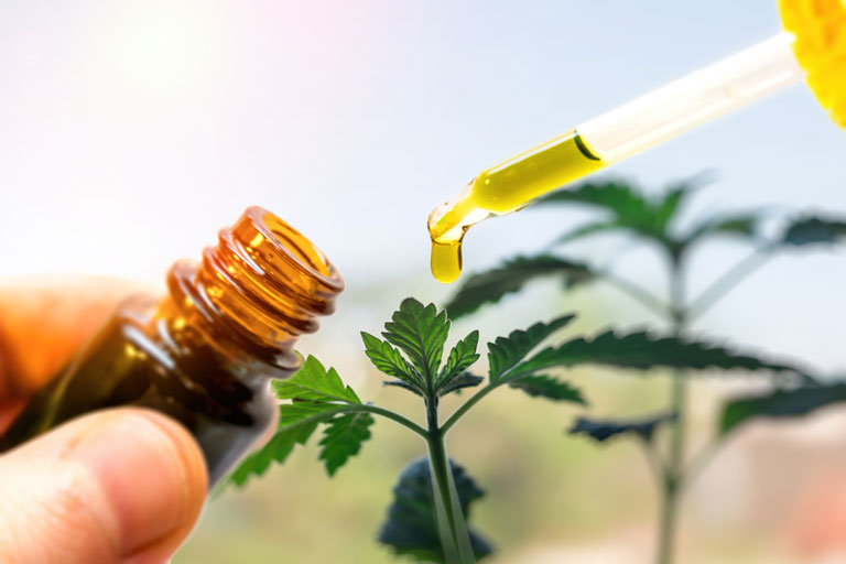 Hand holding a CBD extract