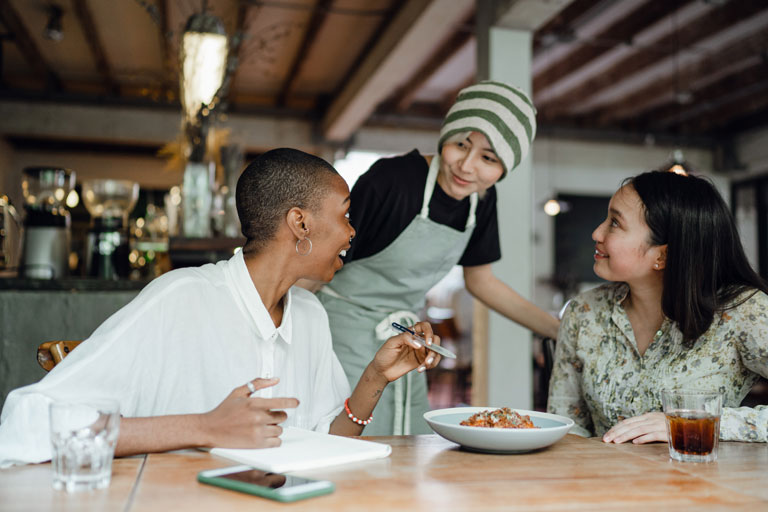3 woman talking in a restaurant