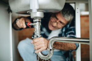 Plumber fixing a kitchen sink