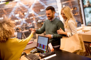 Young couple paying for clothing at a store