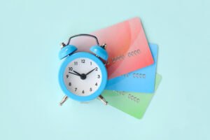 Alarm clock on top of 3 credit cards