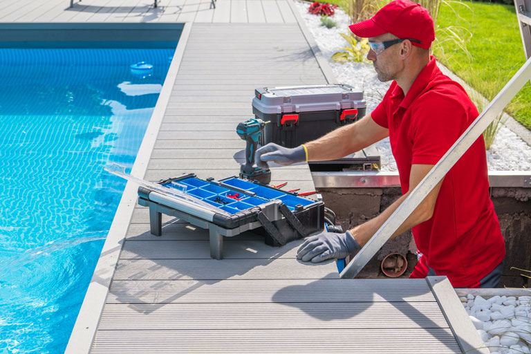 Pool maintenance professional fixing a pool