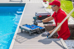 Pool service member fixing a pool