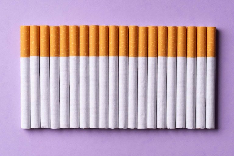 40 lined up cigarettes a purple surface