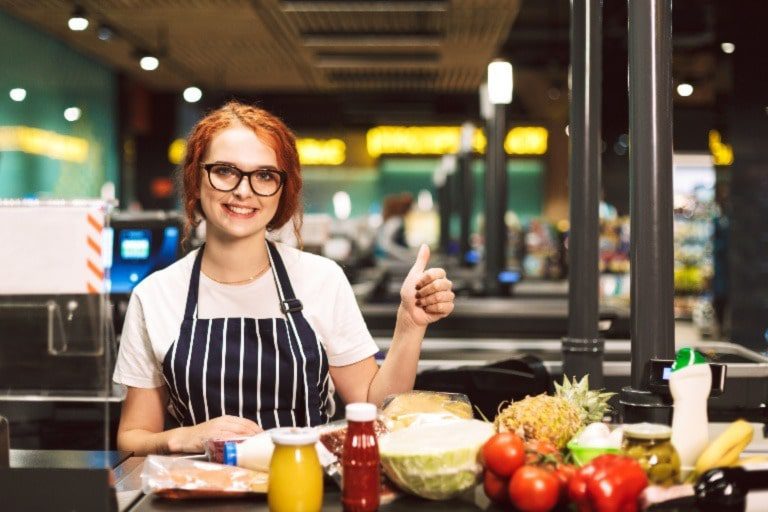 A restaurant employee giving a thumbs up.