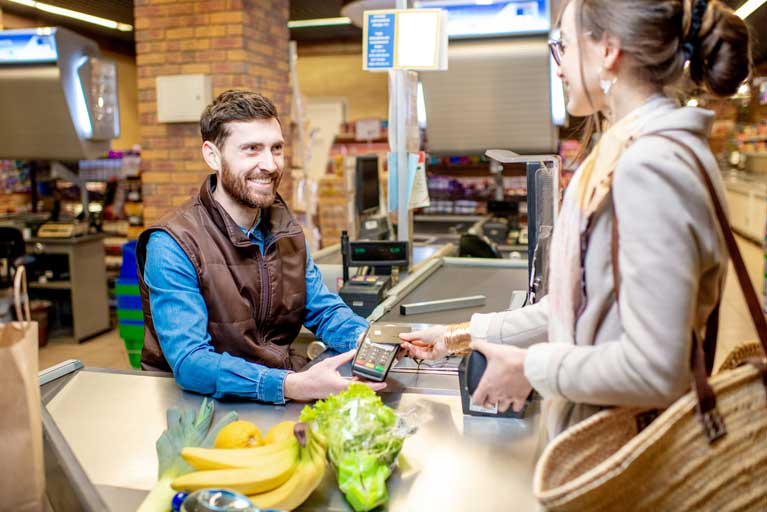 A happy cashier at the grocery store.