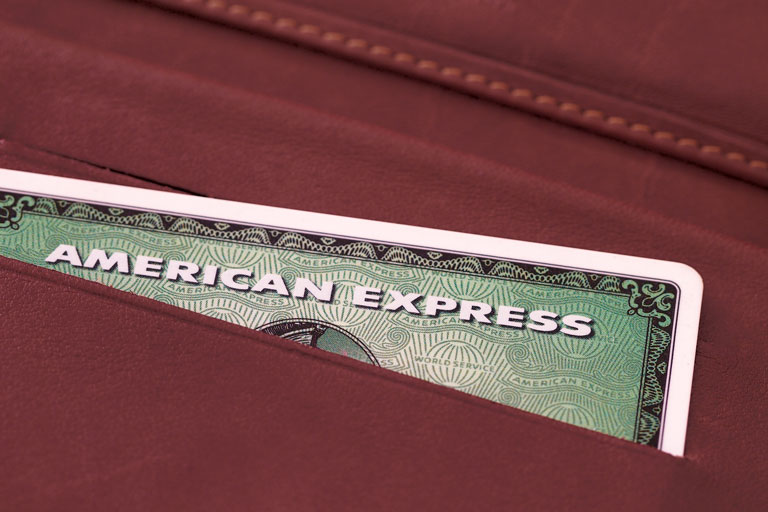 American Express green card inside a burgundy wallet