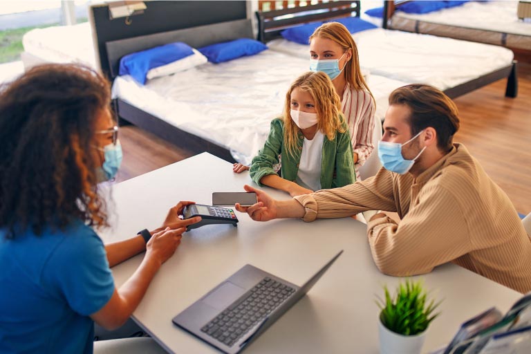 A family at a mattress store using mobile pay.