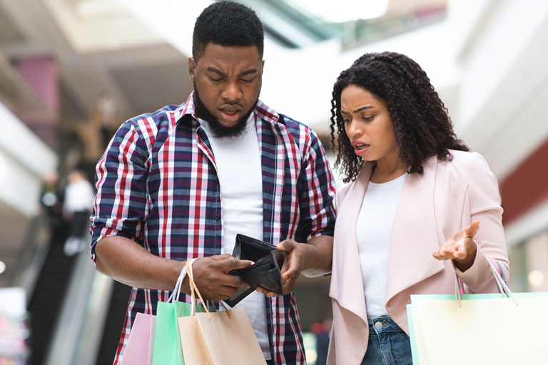 African american couple upset checking their empty wallet inside the mall