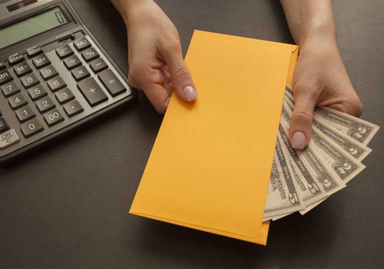 Woman handing out an yellow envelope full of cash