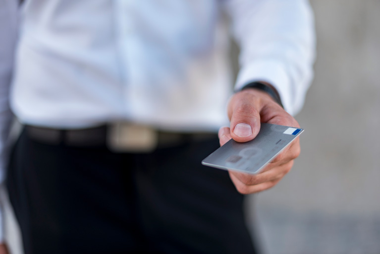 Businessman holding a silver credit card