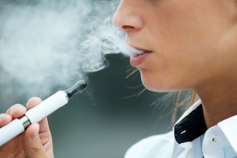 Woman vaping with an e cigarette