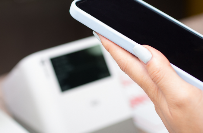 smart phone being used for mobile pay at a clover terminal