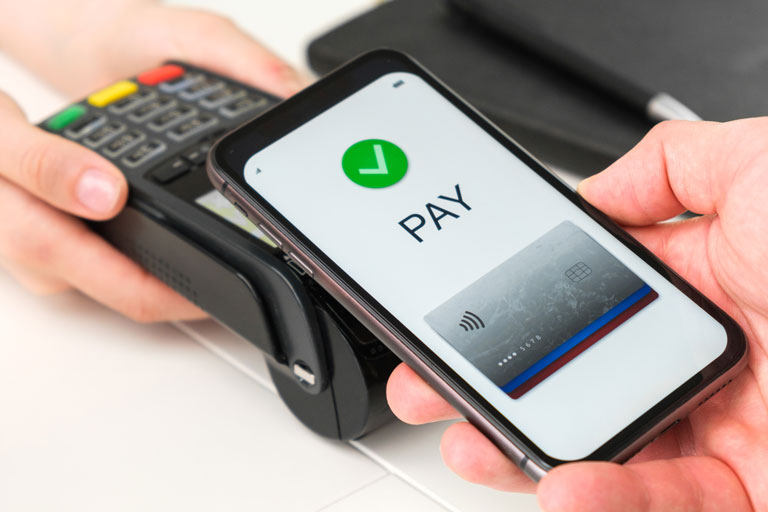 Woman paying with her phone with nfc technology