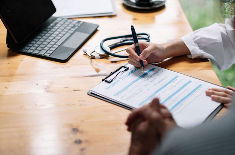 Female doctor showing a patient health insurance paperwork