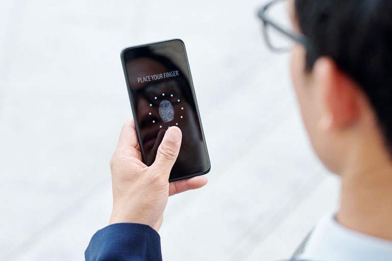 Businessman logging into his phone with fingerprint authentication