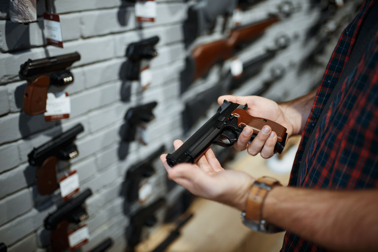 Man holding a gun at a gunshop