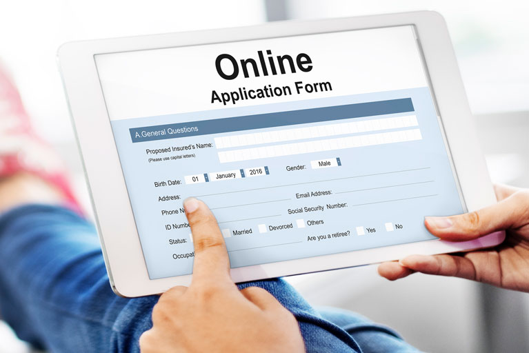 Woman filling out an online application form on her ipad