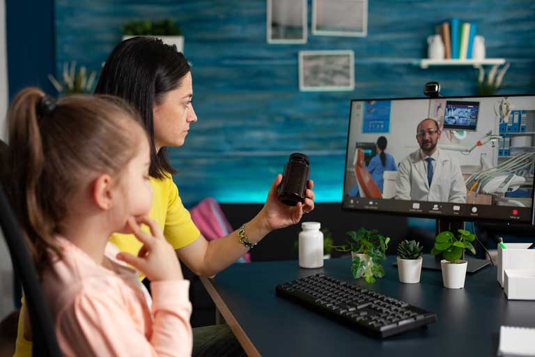 Mother and young daughter discussing medicine options with a doctor via virtual healthcare