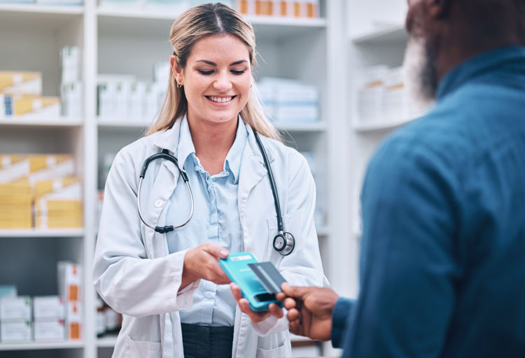 Pharmacist receiving payment from a customer through a contactless point of sale