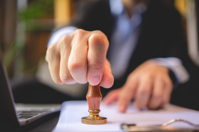 Businessman stamping a paper