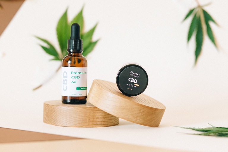 A container of premium CBD oil and CBD ointment being displayed at a store