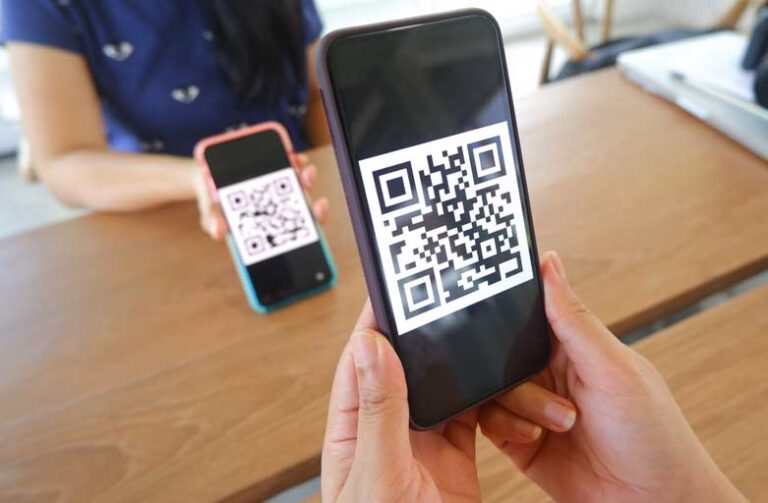 Woman scanning a QR code with her smartphone on another woman's phone