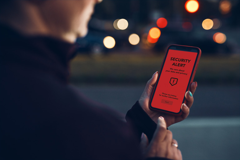 Woman checking a Security alert on her smartphone screen