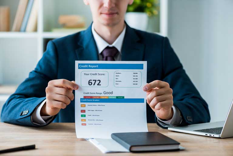 Businessman showing a printout of a credit score report of 672