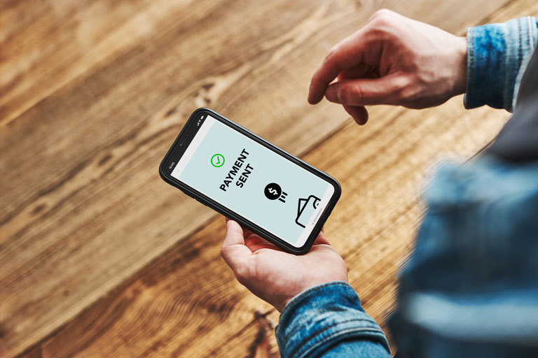 Man sending a payment with his smartphone