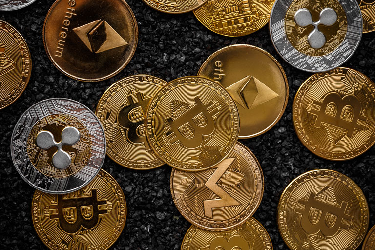 Different types of cryptocurrency coins laying on top of each other