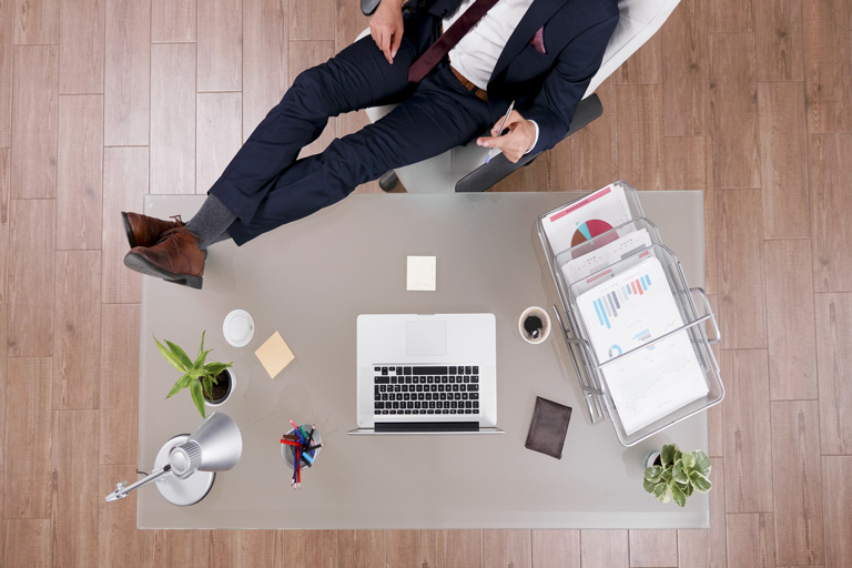 Businessman relaxing his feet on a table in his office