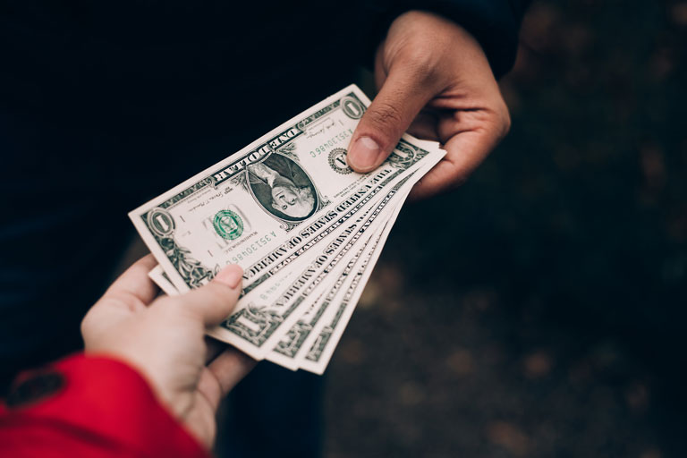 woman handing cash to a man