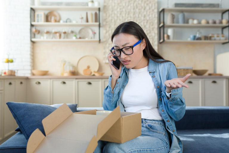 Woman arguing on the phone because she received the wrong package