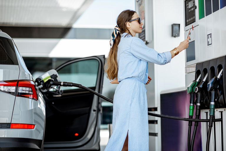 Woman paying for gas at a gas station with her phone