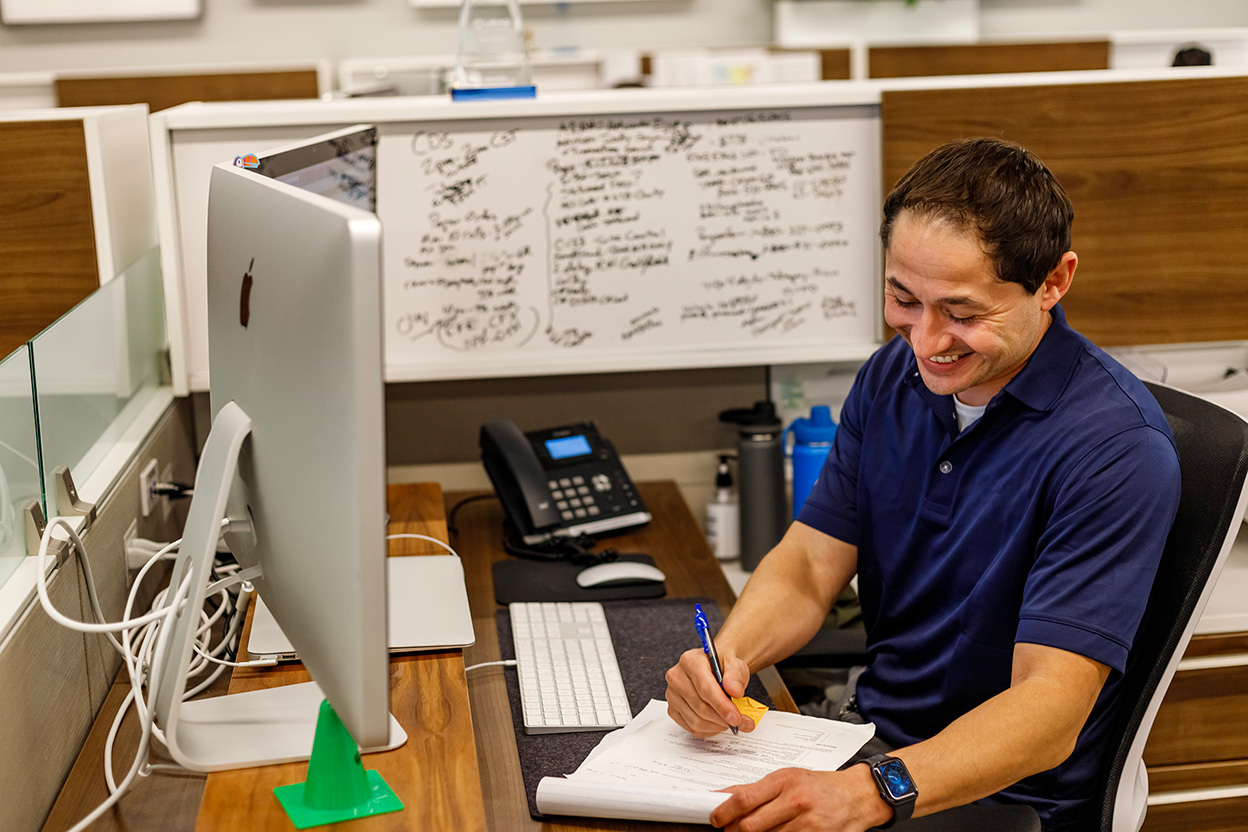 One of our team members looking at a report and smiling