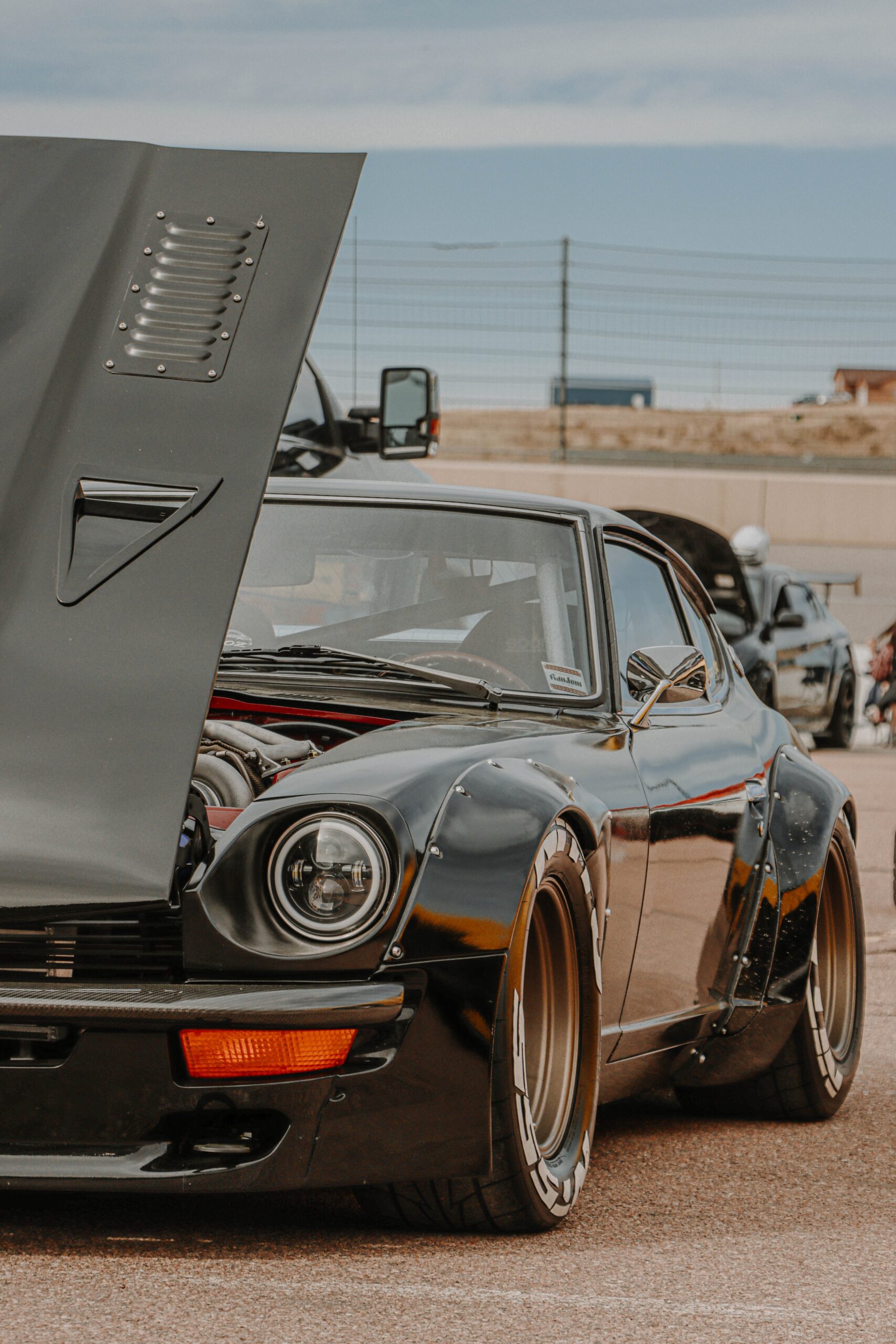 Classic black car with the hood popped