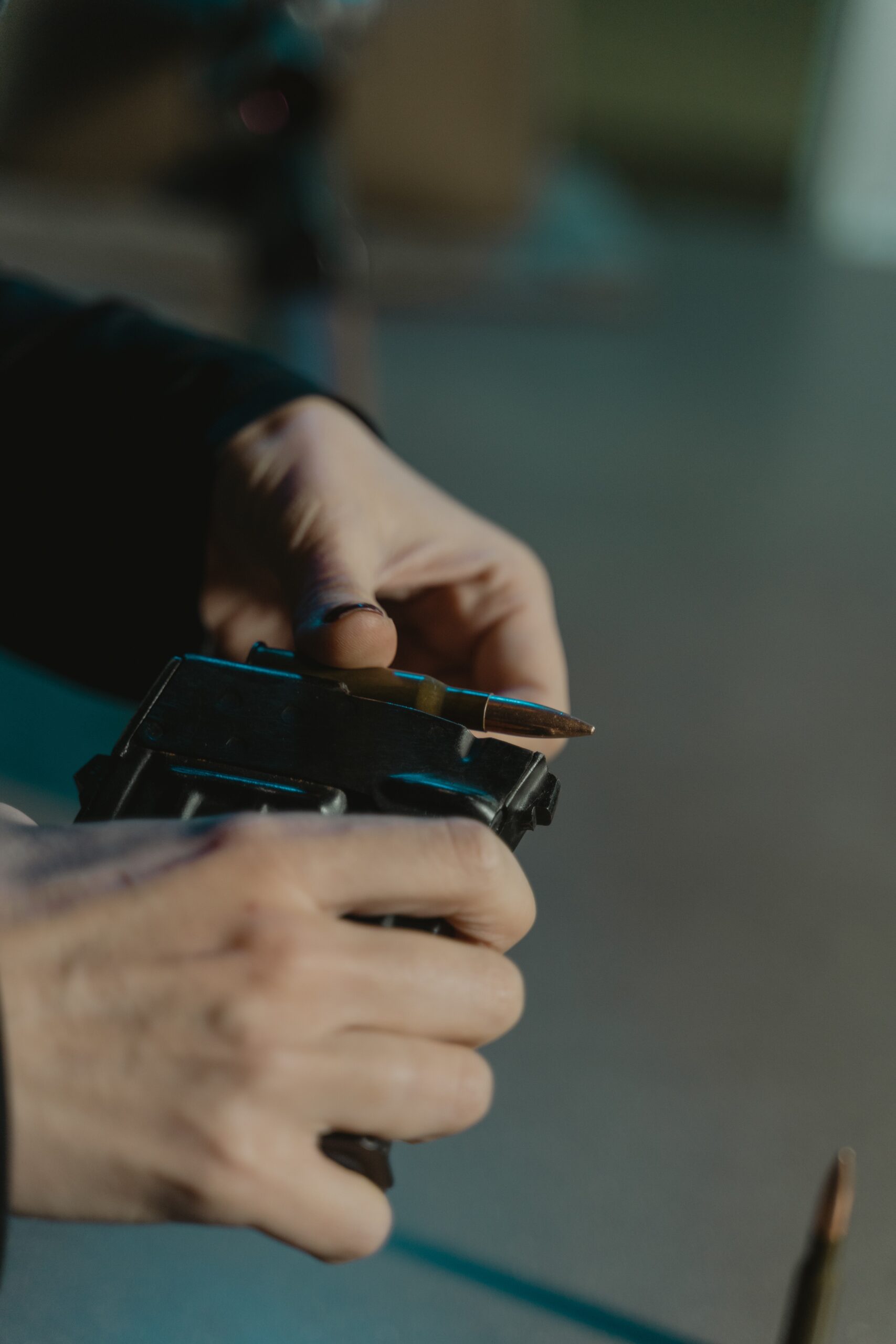 hands reloading a gun cartridge