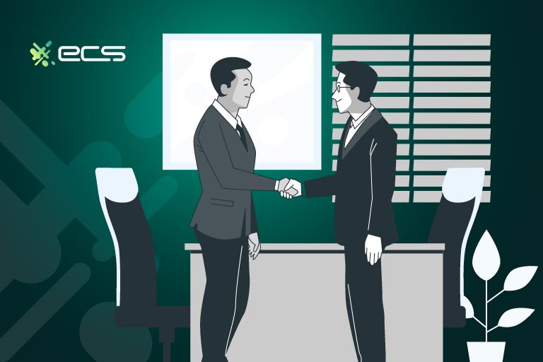 2 male executives shaking hands inside an office