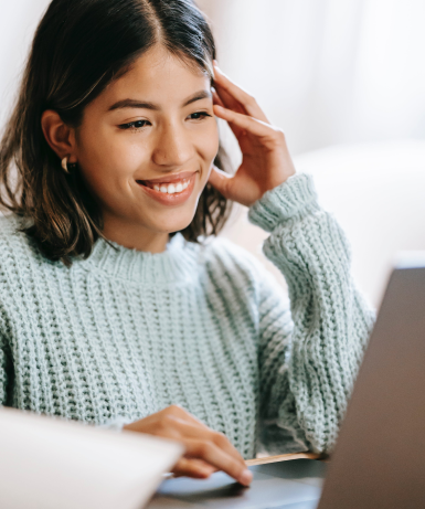 Woman smiling at her computer